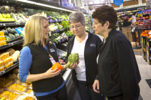 Ashley Honeycutt talking about nutrition with two shoppers