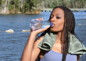 Woman drinking water on a sunny day