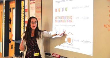 PhD student Maren Cannon teaches students about genomes.