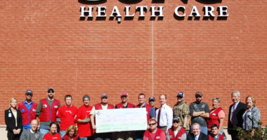 Lowes Heroes present an in-kind check to the Center for Rehabilitation Care