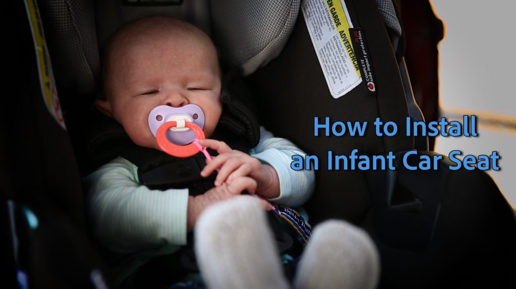 newborn in an infant car seat