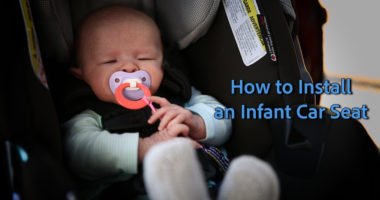newborn in an infant car seat