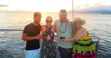 Two couples on a boat at sunset
