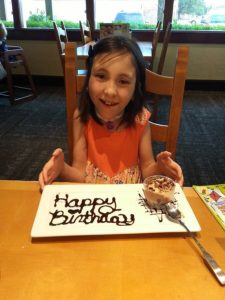 Avery with a happy birthday dessert