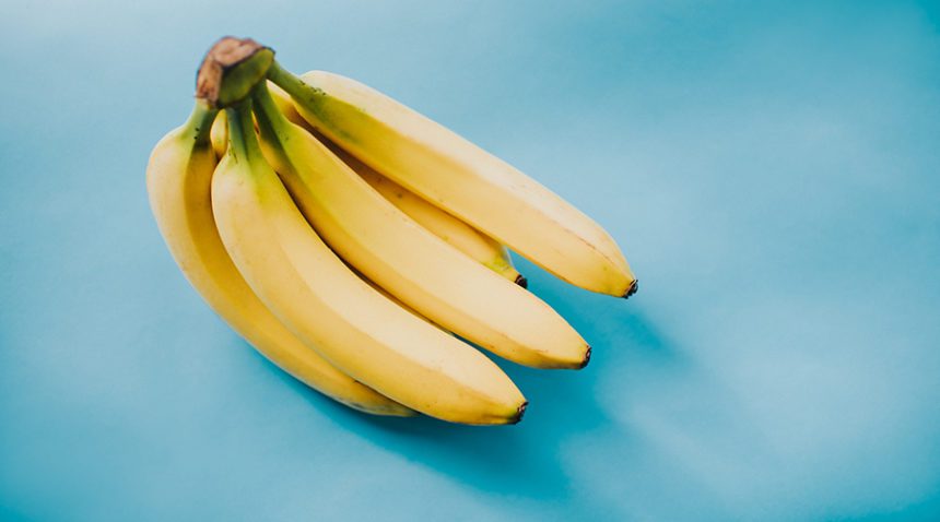 Bunch of Bananas on a blue backdrop.