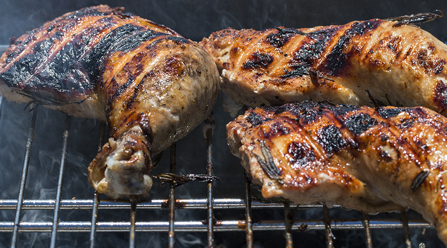 Some Chicken Thighs On A Barbecue.