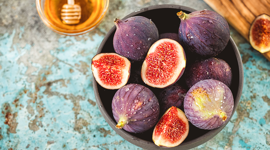 Fresh organic figs and sweet honey on the rustic background