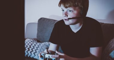 boy playing video games, eyes concentrating on the screen
