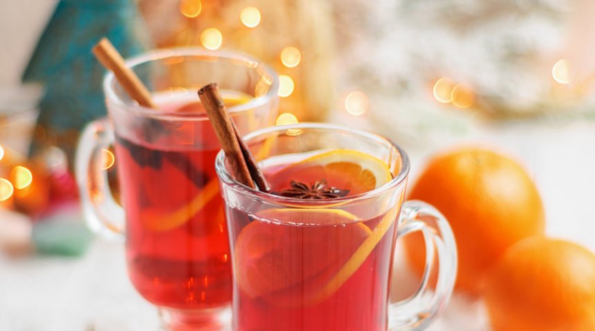 Two glasses of mulled wine with spices, oranges