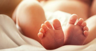 Feet of a newborn baby with a blurred focus.