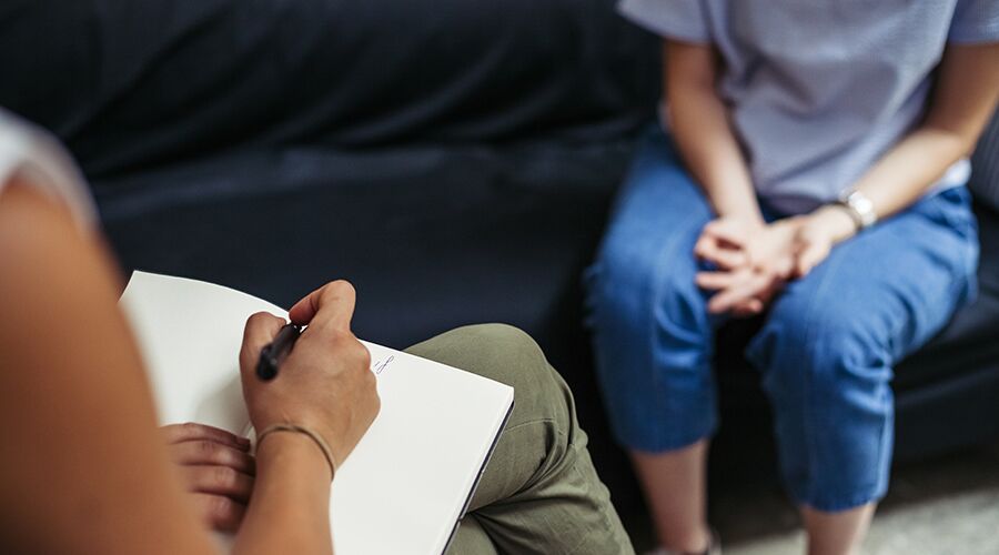 midshot of therapist talking to patient