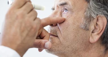 older man having vision examined by doctor