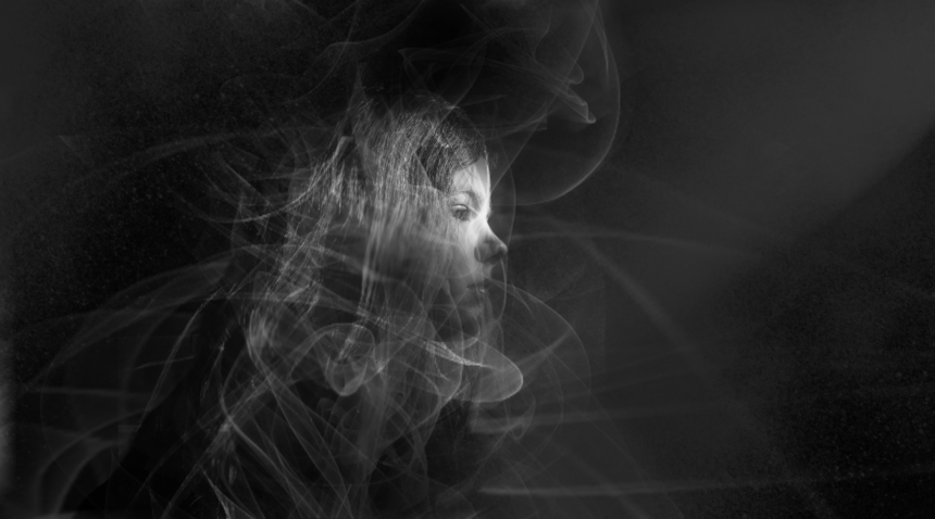 Photo of a child surrounded by cigarette smoke.