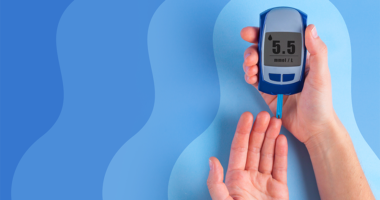 A person's hand being checked for blood sugar levels.