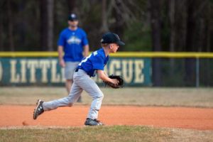 A photograph of Sam playing baseball.