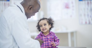 Toddler girl talking to doctor