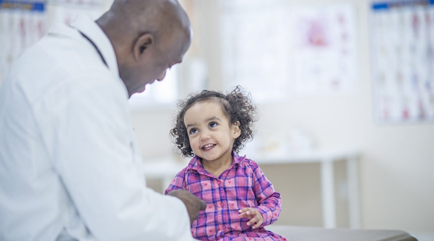 Toddler girl talking to doctor