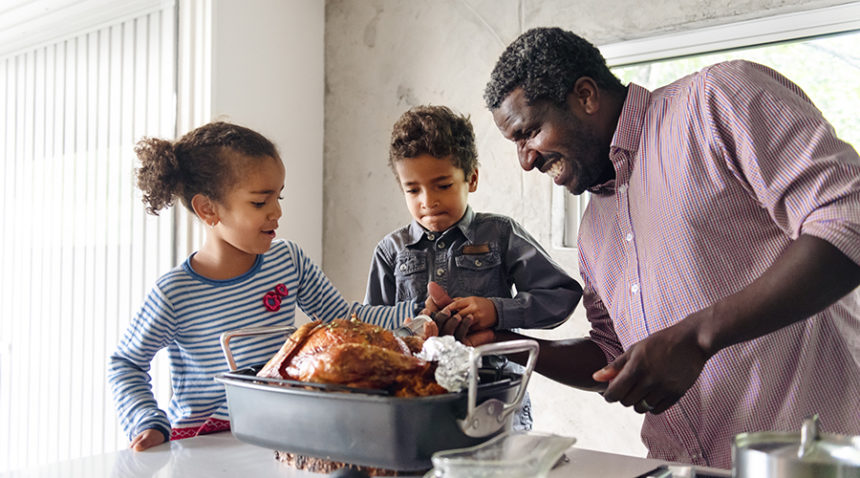 Fathers preparing thanksgiving turkey