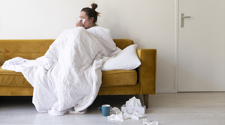 A woman feeling sick in a modern living room.