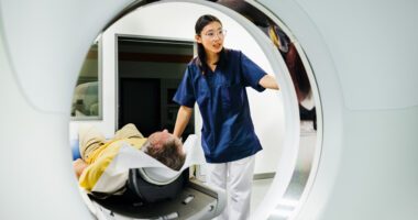 Imaging tech prepares patient to go through CT Scanner