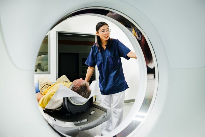 Imaging tech prepares patient to go through CT Scanner