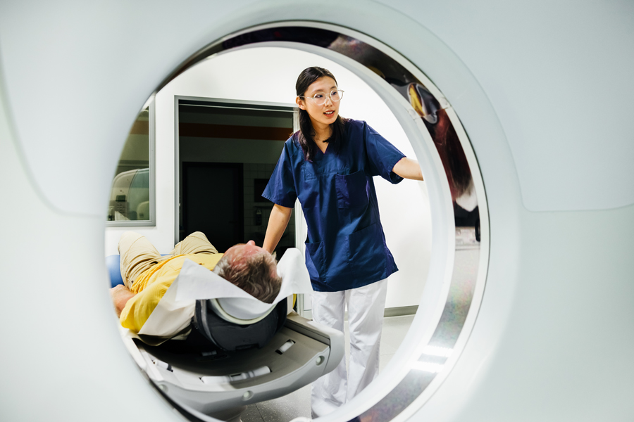 Imaging tech prepares patient to go through CT Scanner