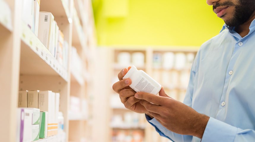 Man Chooses Supplement In Drugstore