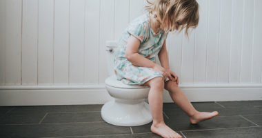 Little toddler, potty training on tiny toilet