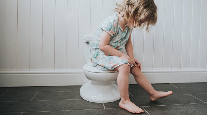Little toddler, potty training on tiny toilet