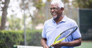 Portrait of a senior man with a tennis racket
