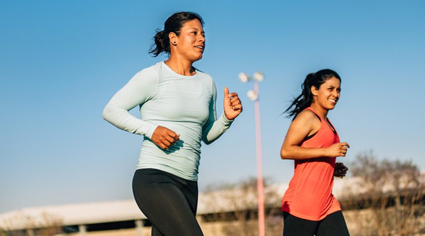 two women running together outside