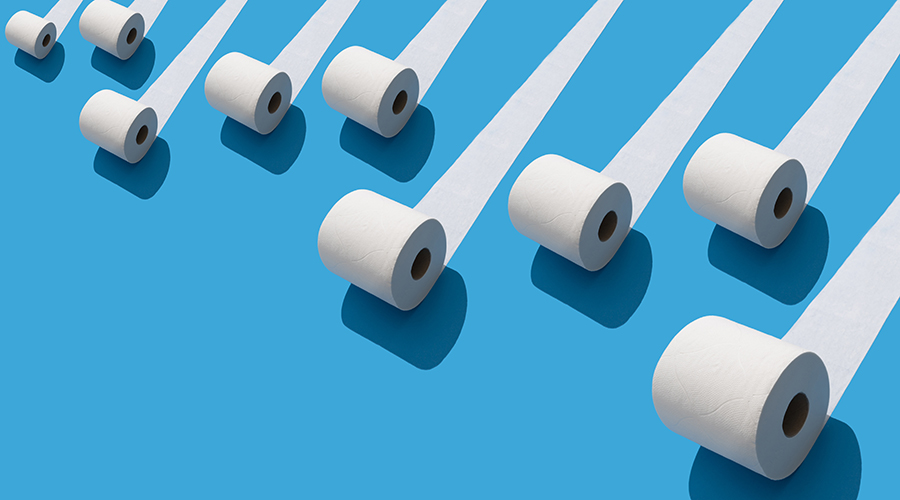 Elevated view of many toilet rolls on blue background