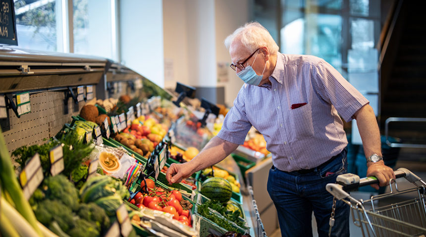 Man with face mask buying groceries
