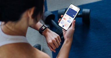 Woman using exercise tracking app on smartphone