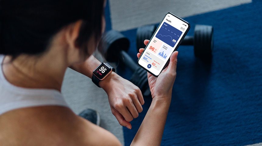 Woman using exercise tracking app on smartphone