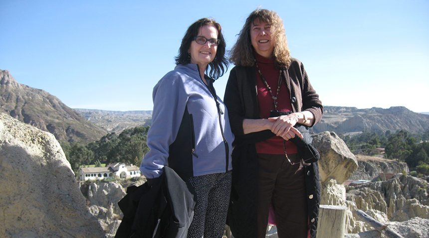 Two women standing on a mountain