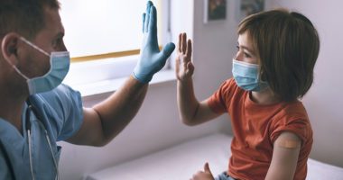 Child giving doctor a high-five