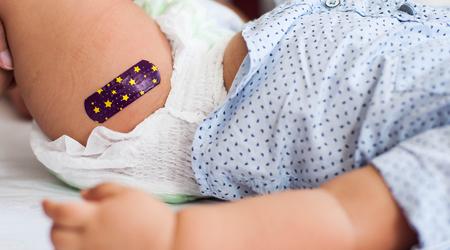 Small child with band-aid after vaccine shot
