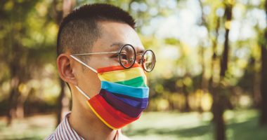 Person wearing a pride mask