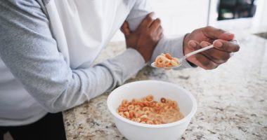 Close up of a person eating a bowl of cereal