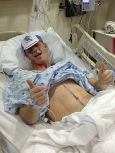 UNC patient Alex Werden, giving a thumb's up from his hospital bed after a surgery