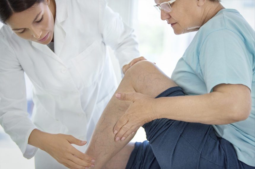 Provider examines a patient's leg