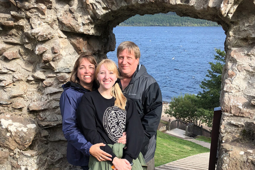 UNC Health patient Brian Stepien with his family, outdoors in front of a rock structure