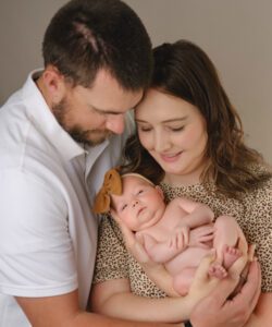 Caroline with her husband and newborn daughter in January 2023