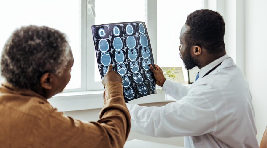 Young doctor man looking x-ray of the patient's skull