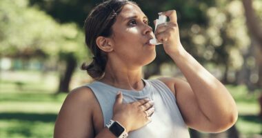 Runner using asthma inhaler