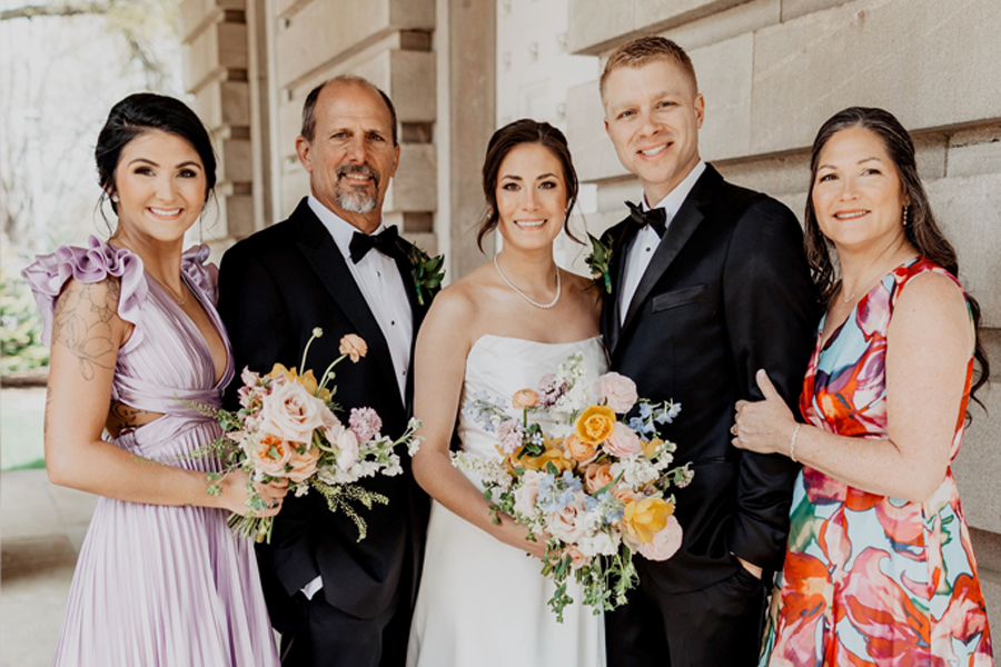 Susan celebrates a special moment with her family at a wedding.