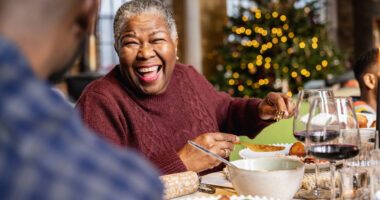 Older woman enjoying a Christmas meal.