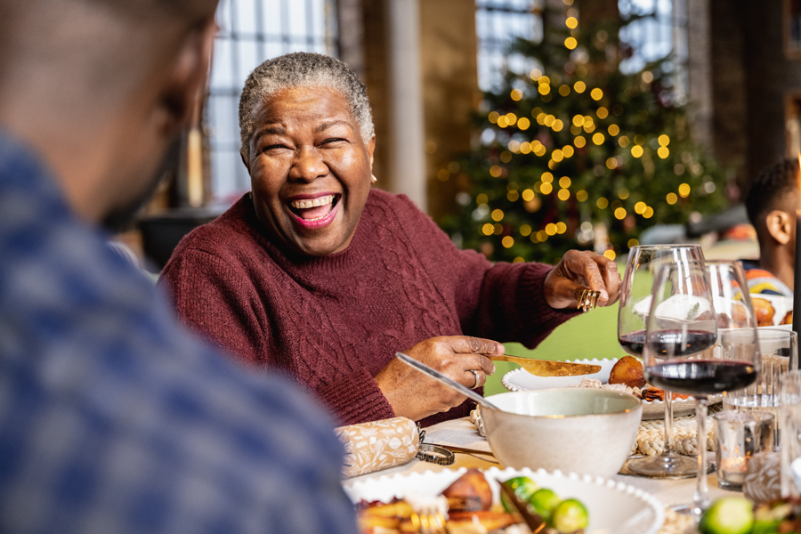 Older woman enjoying a Christmas meal.