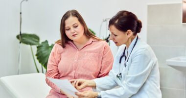 woman sits with provider, discussing test results